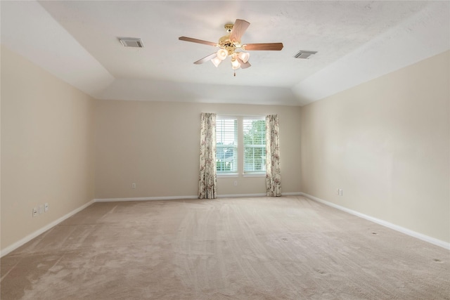 spare room with ceiling fan, light colored carpet, and lofted ceiling