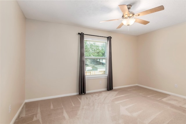 spare room featuring light carpet and ceiling fan