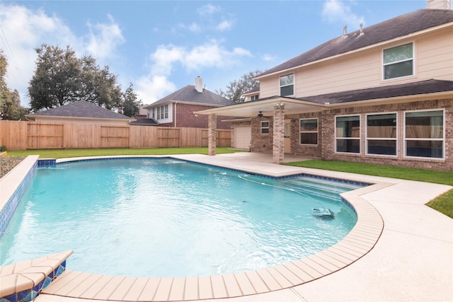 view of pool featuring a patio area, a yard, and pool water feature