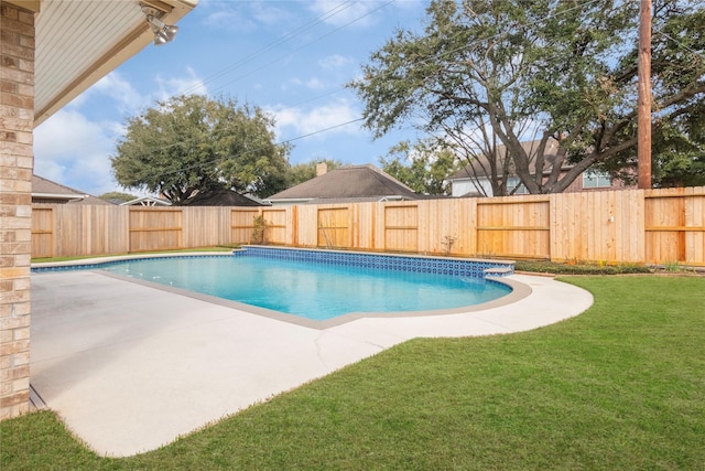 view of swimming pool with a lawn and a patio area