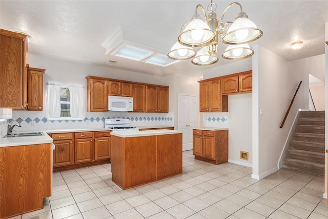 kitchen with light tile patterned floors, sink, a kitchen island, range, and tasteful backsplash