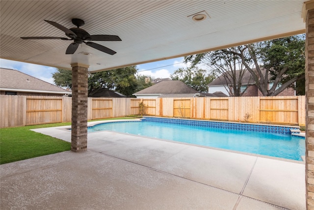 view of swimming pool with ceiling fan and a patio area