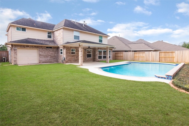 view of pool featuring a patio and a yard