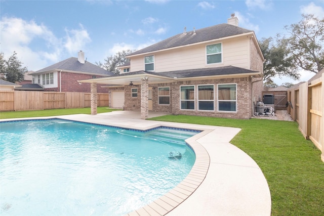 view of pool featuring a lawn, a patio area, and central air condition unit