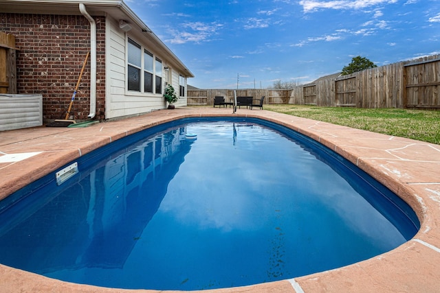 view of swimming pool featuring a fenced backyard and a patio