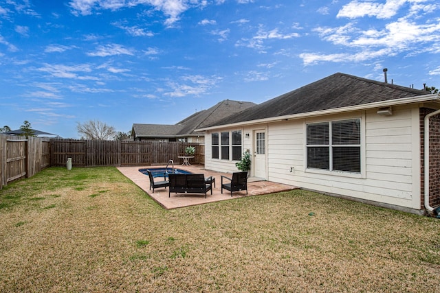 rear view of property featuring a patio and a shingled roof