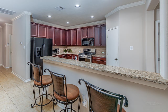 522 Arbor Green Ln, Rosenberg, TX 77469 - kitchen with black appliances, reddish brown cabinets, tasteful backsplash, ornamental molding, and light tile patterned floors