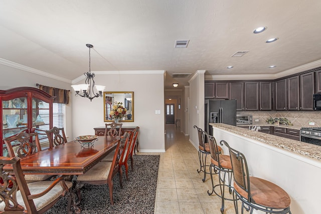 522 Arbor Green Ln, Rosenberg, TX 77469 - dining space featuring a chandelier, ornamental molding, light tile patterned floors, recessed lighting, and baseboards