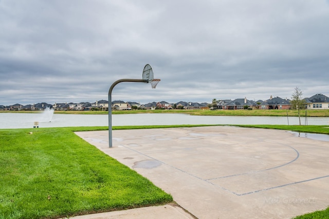 view of basketball court with a residential view, community basketball court, and a yard