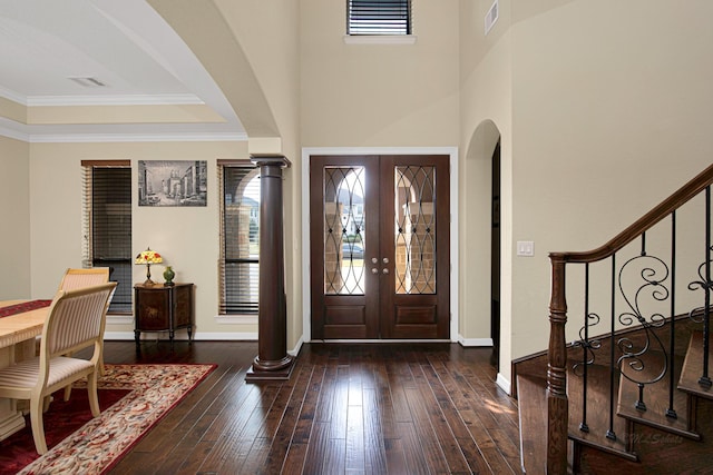 entrance foyer with wood-type flooring, stairs, visible vents, and ornamental molding