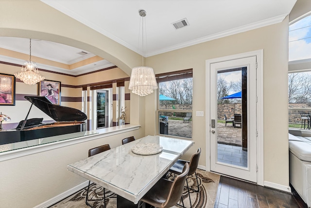 dining space with a chandelier, a wealth of natural light, and hardwood / wood-style floors