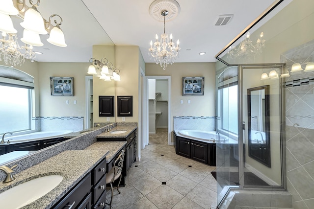 bathroom with double vanity, a stall shower, visible vents, and a sink