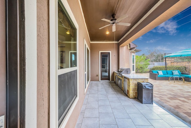 view of patio / terrace featuring area for grilling, a grill, ceiling fan, fence, and an outdoor living space