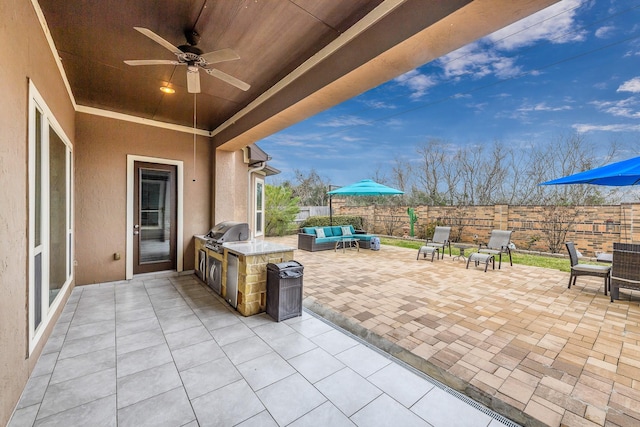 view of patio / terrace with ceiling fan, an outdoor kitchen, a fenced backyard, an outdoor living space, and grilling area