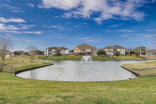 property view of water featuring fence and a residential view