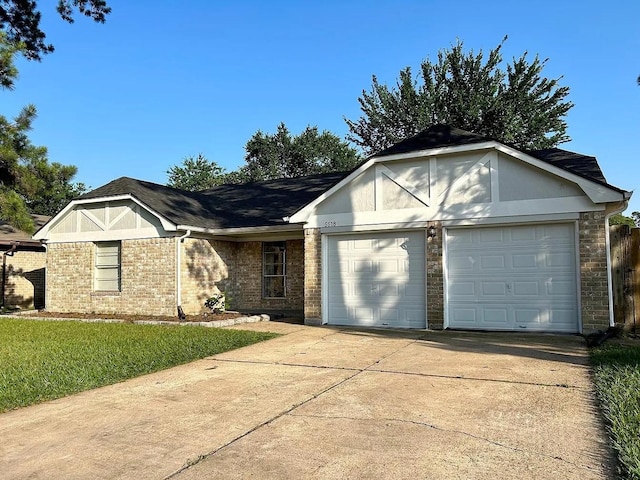 view of front of home featuring a front yard and a garage