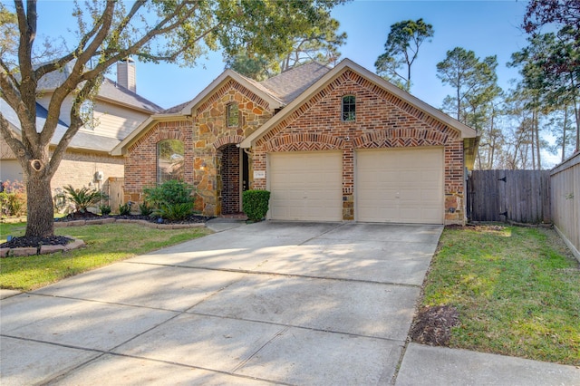 view of front of house featuring a front lawn and a garage