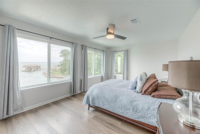 bedroom with light hardwood / wood-style flooring and ceiling fan