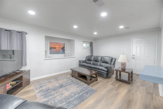 living room with light wood-type flooring and crown molding