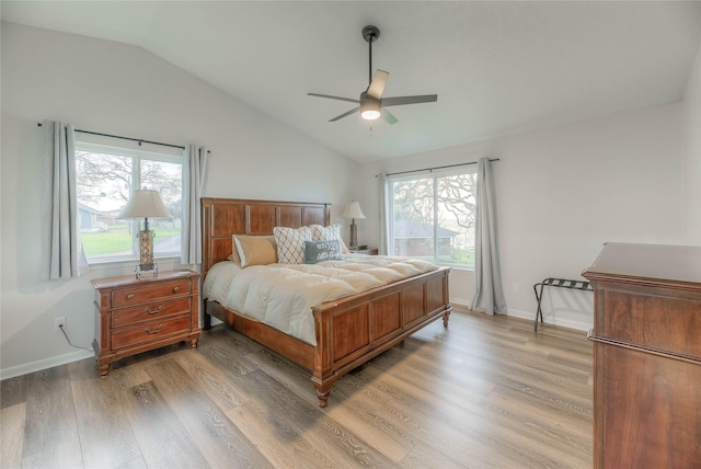bedroom featuring hardwood / wood-style flooring, ceiling fan, and lofted ceiling