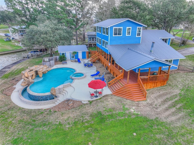 view of pool with a patio area, an outbuilding, and an in ground hot tub