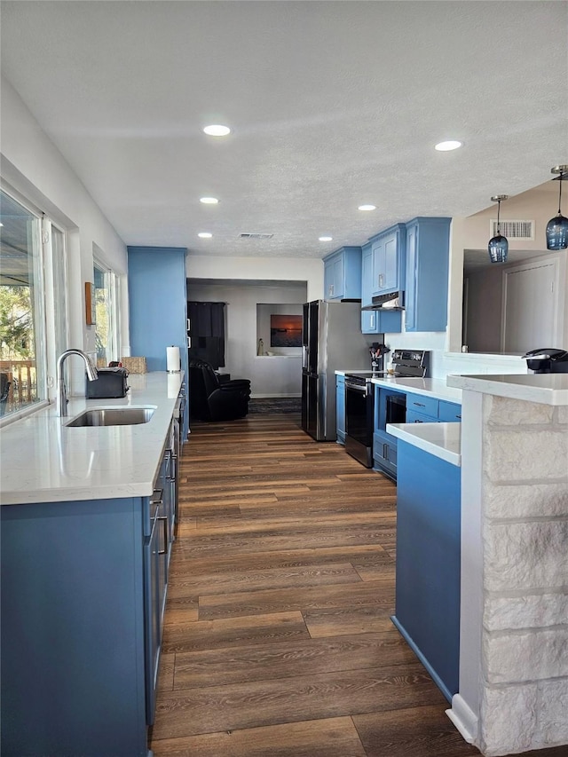 kitchen with range with electric cooktop, hanging light fixtures, dark wood-type flooring, blue cabinets, and sink