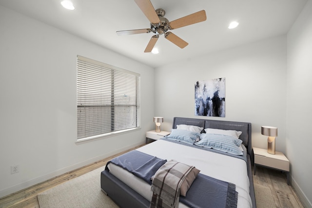 bedroom featuring ceiling fan, baseboards, wood finished floors, and recessed lighting