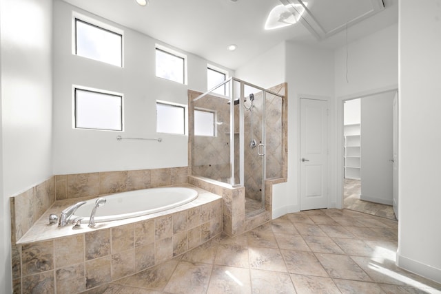 full bathroom with a stall shower, a garden tub, a spacious closet, and recessed lighting