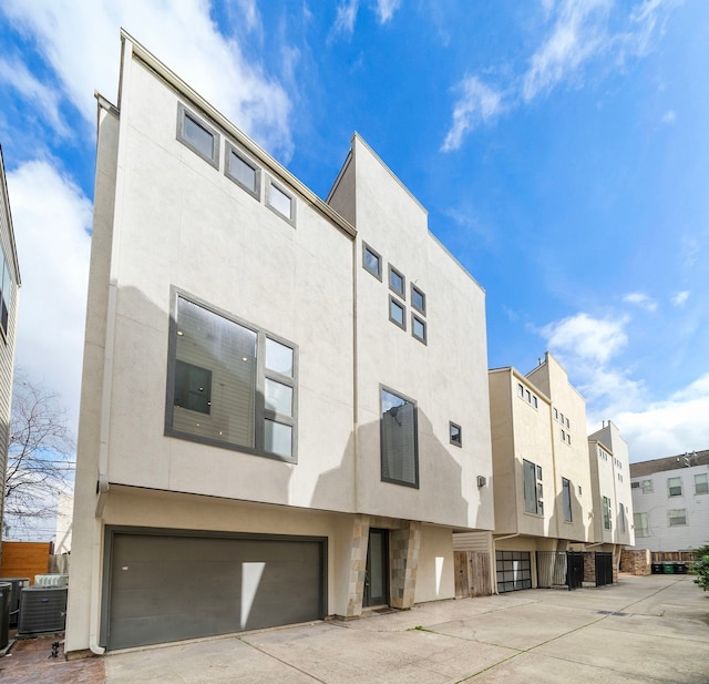 view of property with a garage and central AC