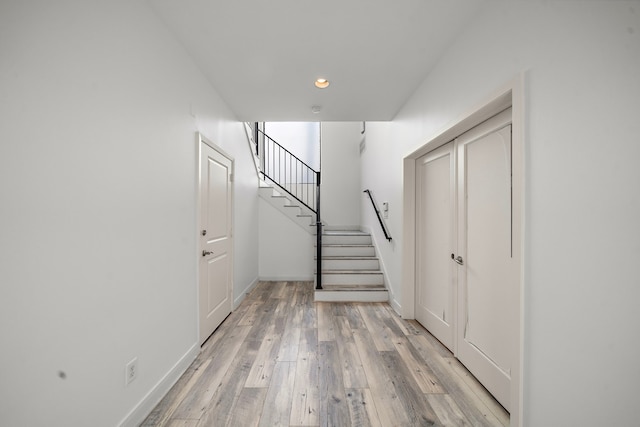 interior space with recessed lighting, wood finished floors, and baseboards