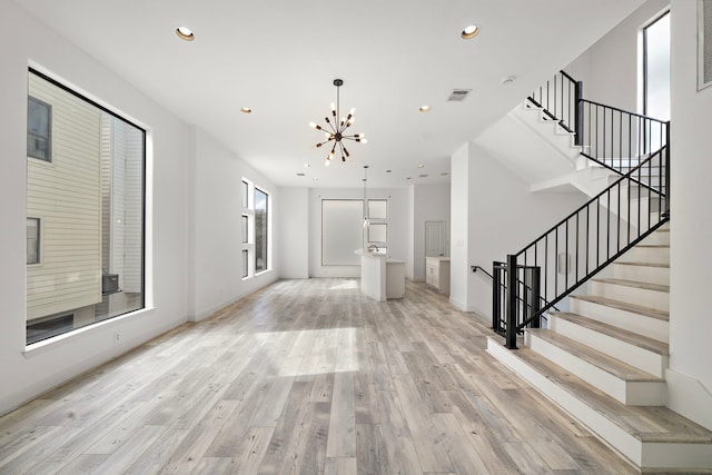 foyer entrance featuring light wood finished floors, stairs, visible vents, and recessed lighting