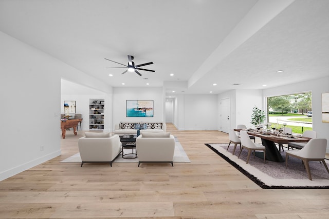 living room featuring light wood-type flooring, baseboards, a ceiling fan, and recessed lighting