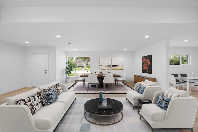 living room with light wood-style floors, baseboards, visible vents, and recessed lighting