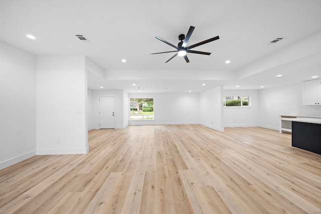 unfurnished living room with light wood-style flooring, visible vents, and recessed lighting