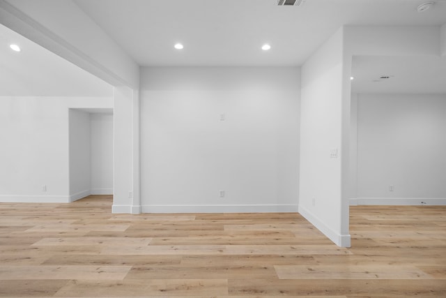 spare room with light wood-type flooring, baseboards, and recessed lighting