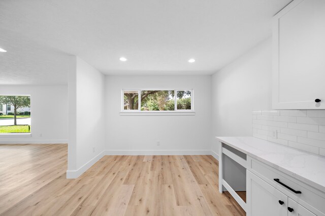 4102 Levonshire Dr, Houston, TX 77025 - unfurnished dining area with light wood-style flooring, recessed lighting, and baseboards