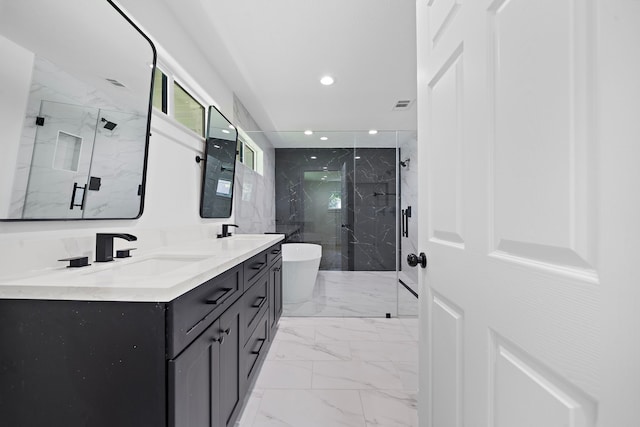 full bath featuring marble finish floor, a marble finish shower, double vanity, recessed lighting, and a sink