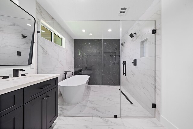 4102 Levonshire Dr, Houston, TX 77025 - full bathroom with marble finish floors, a marble finish shower, vanity, a freestanding bath, and recessed lighting