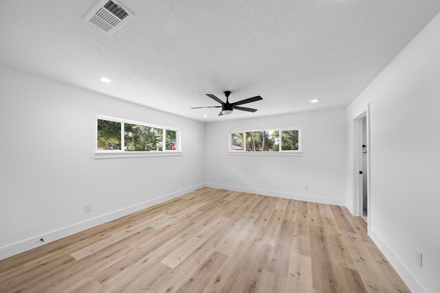 4102 Levonshire Dr, Houston, TX 77025 - empty room featuring plenty of natural light, a ceiling fan, light wood-type flooring, recessed lighting, and baseboards