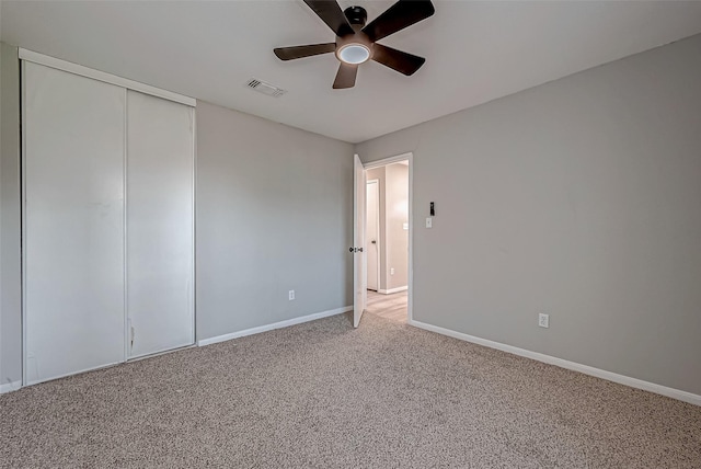 unfurnished bedroom featuring a closet, carpet flooring, and ceiling fan