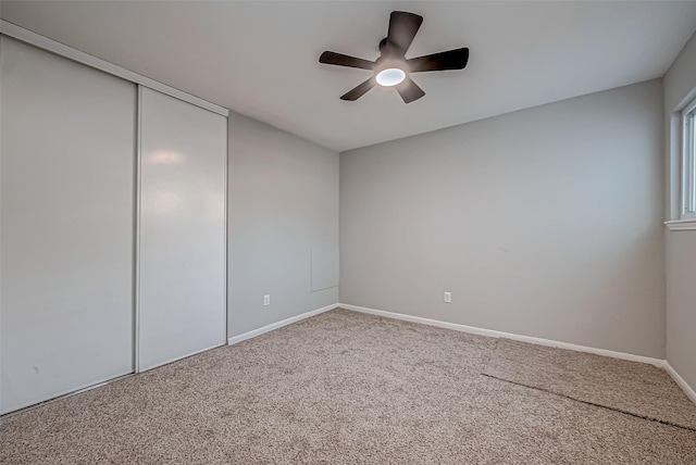 interior space featuring carpet, a closet, and ceiling fan