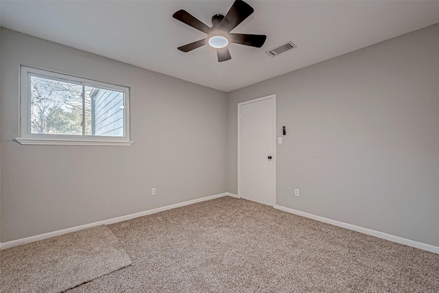 spare room featuring ceiling fan and carpet floors