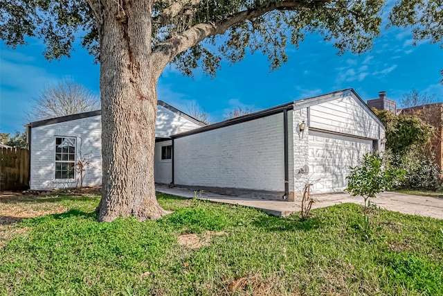 view of side of home featuring a yard