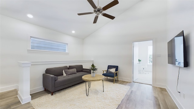 living room featuring light wood-style flooring, baseboards, and recessed lighting