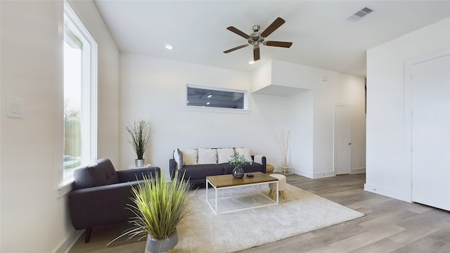 living room featuring recessed lighting, a ceiling fan, baseboards, visible vents, and light wood-type flooring