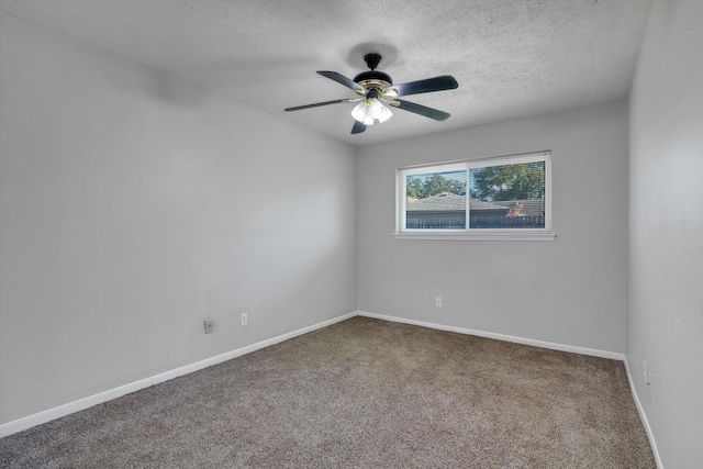 empty room featuring carpet flooring, ceiling fan, a textured ceiling, and baseboards