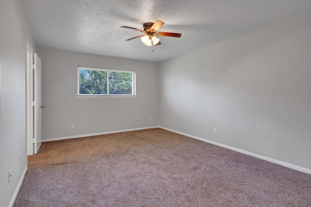 carpeted empty room featuring a ceiling fan, a textured ceiling, and baseboards