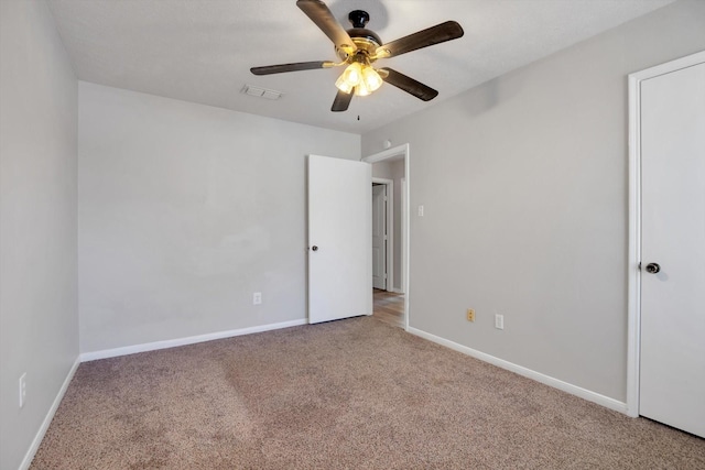 unfurnished bedroom featuring carpet, visible vents, and baseboards