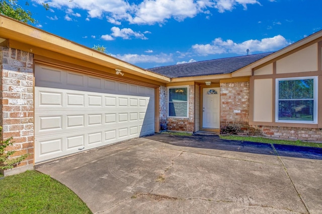 view of front of house featuring concrete driveway, brick siding, and an attached garage