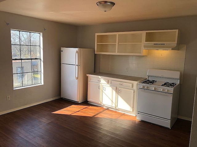 kitchen with white appliances, white cabinets, dark hardwood / wood-style floors, and tasteful backsplash